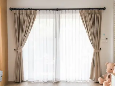 A lounge accentuated with beige woven sheer curtains